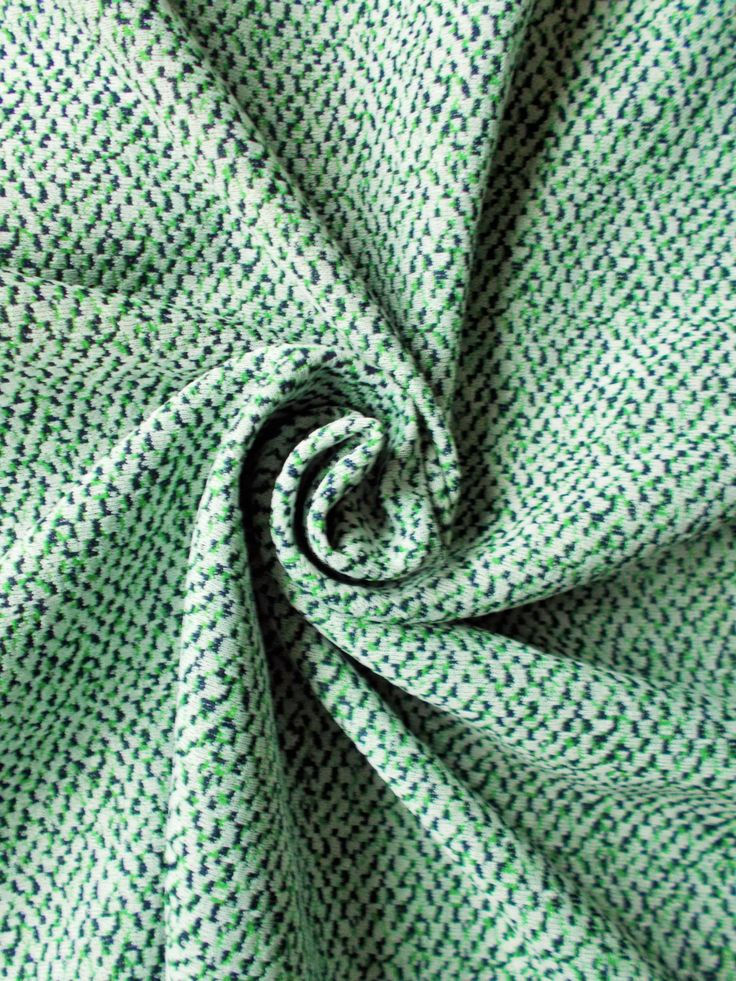 Close-up of textured vintage Crimplene fabric showing its distinctive bulky knitted surface.