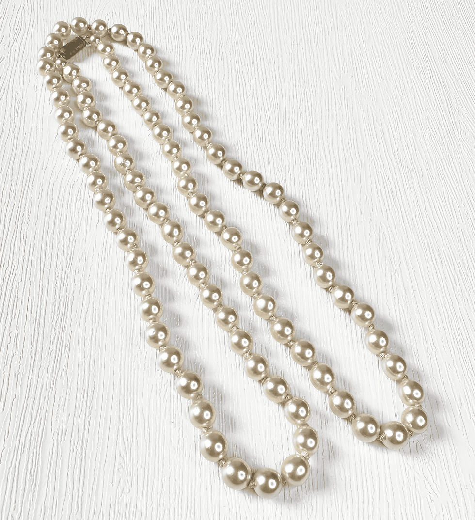 Thumbnail: 1950s vintage faux pearl necklace shown as a single long strand with clasp at top.