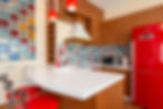 Modern kitchen using a neutral backdrop with bold red accents to demonstrate the 60-30-10 colour rule.