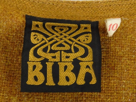 Close-up of a brown knit garment label reading BIBA, with a small size 10 tag on the right.