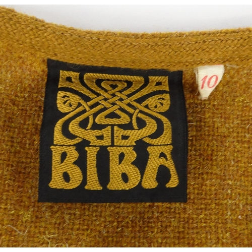 Close-up of a brown knit garment label reading BIBA, with a small size 10 tag on the right.
