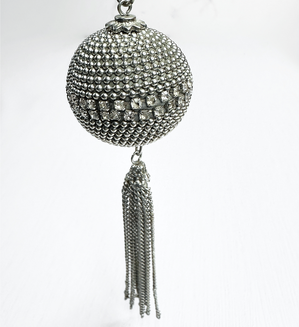 Thumbnail: Detailed close-up of rhinestone-encrusted orb pendant with hanging silver tassel chains.