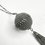 Thumbnail: Close-up of vintage silver-tone orb pendant with rhinestone detailing and tassel chains.