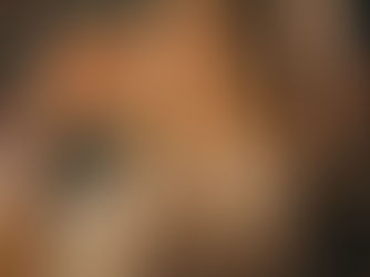 Woman dancing in a sparkling sequin outfit against a shimmering backdrop