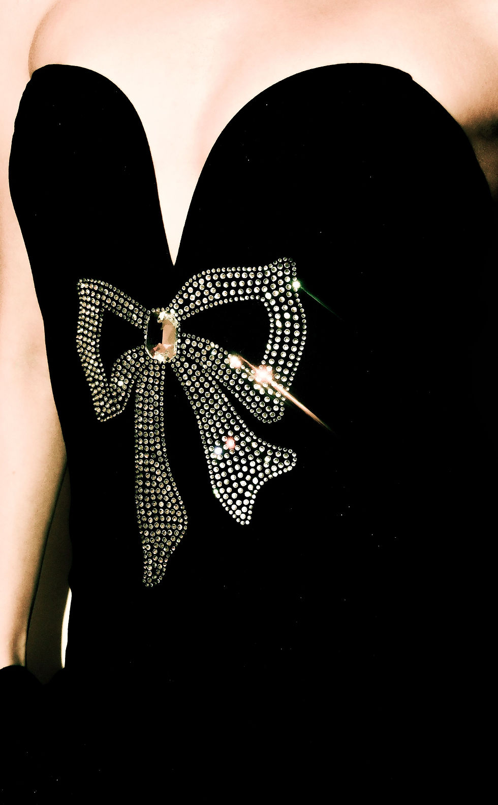 Diamanté statement bow decorating a black evening dress