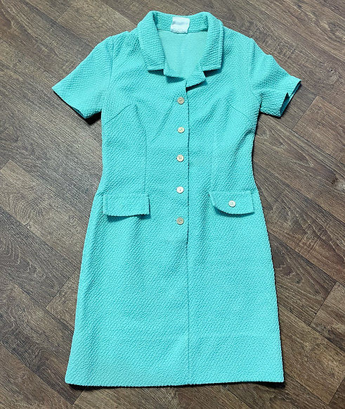 Original turquoise vintage Crimplene dress showing the fabric's distinctive textured surface and structured silhouette.