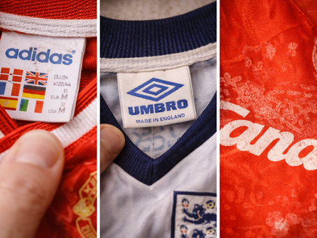 Close-up of three football shirt tags: Adidas with flags, Umbro with "Made in England," and a red Candy jersey with a blurred pattern.