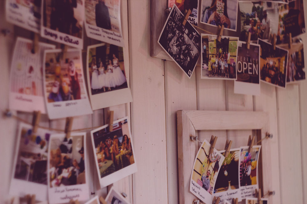 Collection of instant photographs displayed on a wall, illustrating nostalgia and the memories that inspire the return of retro trends.