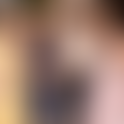 Elegant group of three women in 1950s vintage dresses and a man in a 1950s suit, smiling on a lively street. Dresses feature floral, gingham and polka dot patterns.