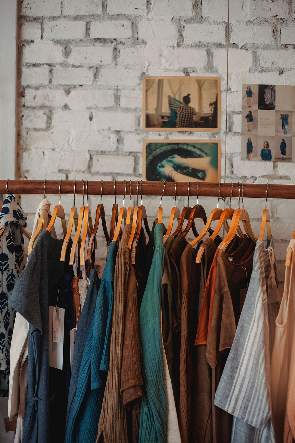 A carefully curated clothing rail in a boutique, representing the sourcing, preparation and presentation behind quality vintage fashion.
