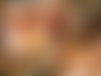 Woman trying on red cat eye sunglasses inside colourful vintage clothing boutique