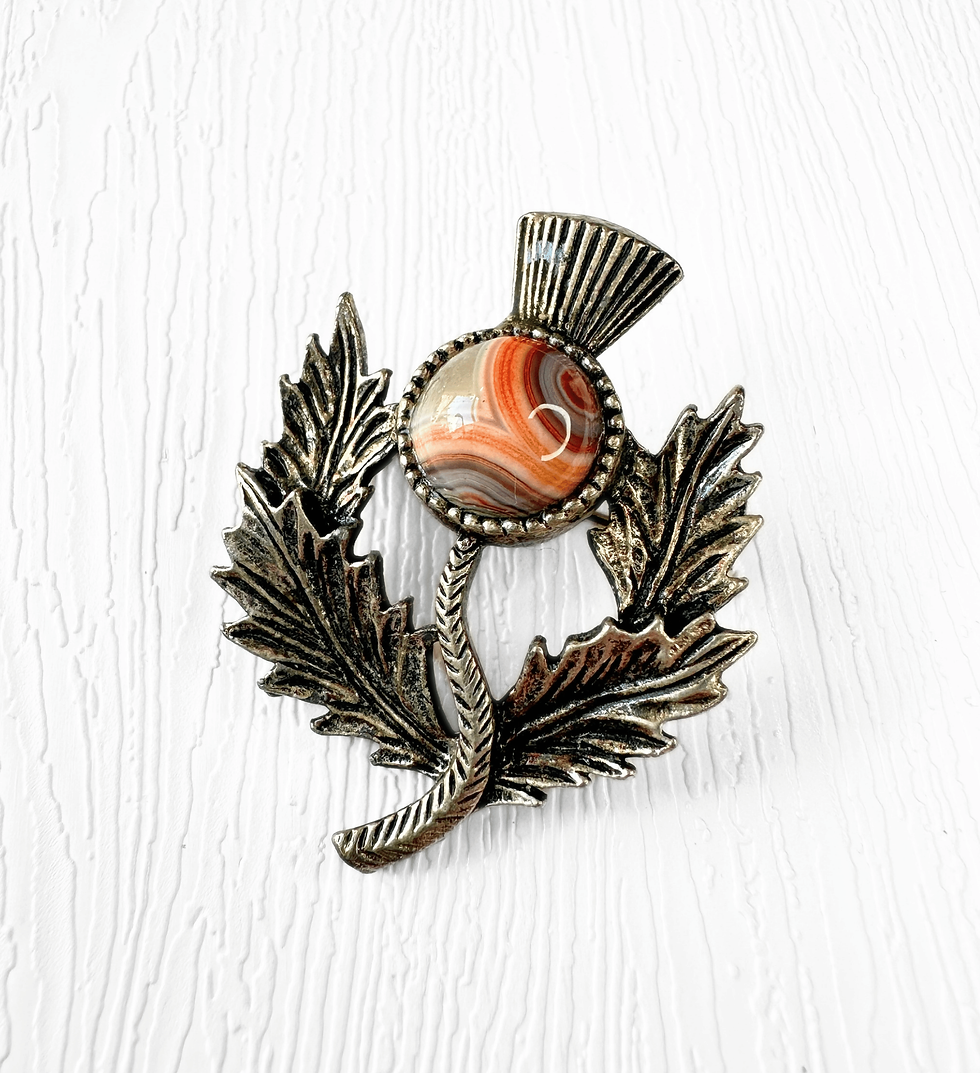 Vintage Scottish thistle brooch with orange and cream marbled cabochon centre