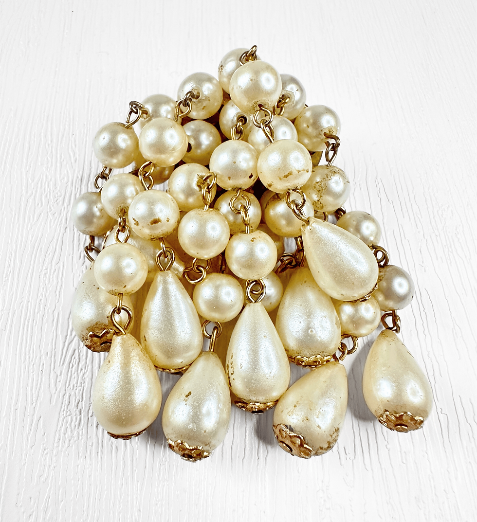 Close view of 1950s pearl cascade brooch highlighting clustered faux pearls and detail