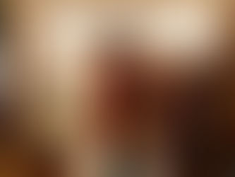 Woman browsing dresses in a vintage shop UK