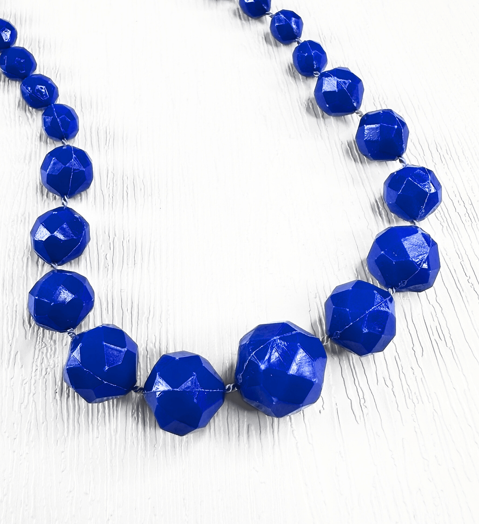 Thumbnail: Close up of 1960s cobalt blue faceted beads showing graduated design