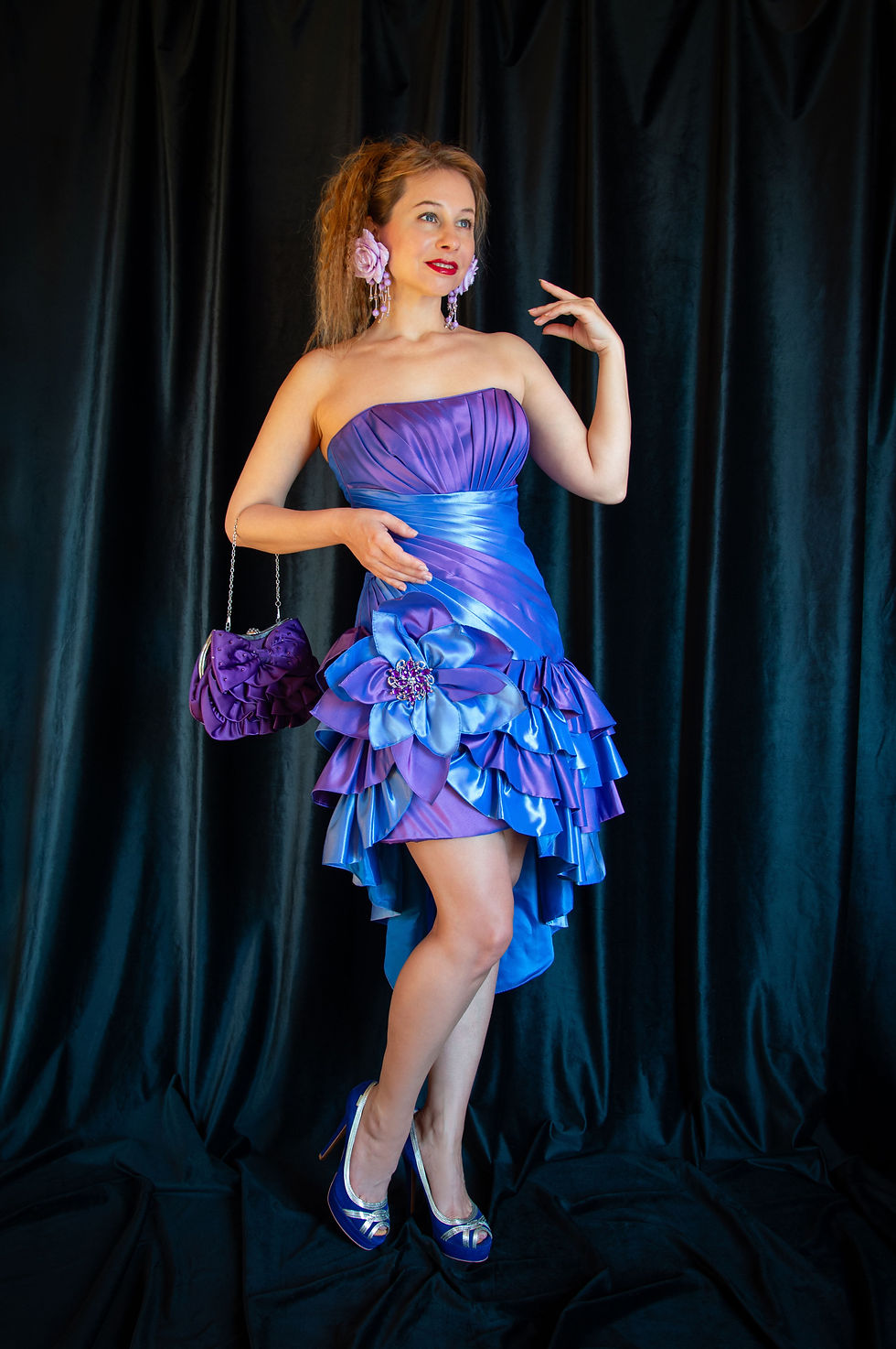 Woman modelling a colourful purple and blue 1980s-style cocktail dress