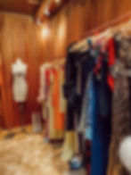 Curated collection of vintage designer clothing displayed in an elegant boutique, celebrating timeless fashion and craftsmanship.