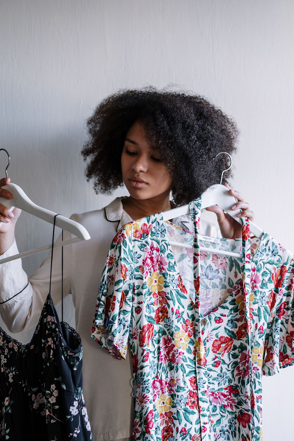 Woman choosing between vintage dresses