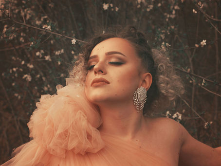 Woman wearing elegant vintage-inspired fashion with statement earrings, celebrating timeless personal style.