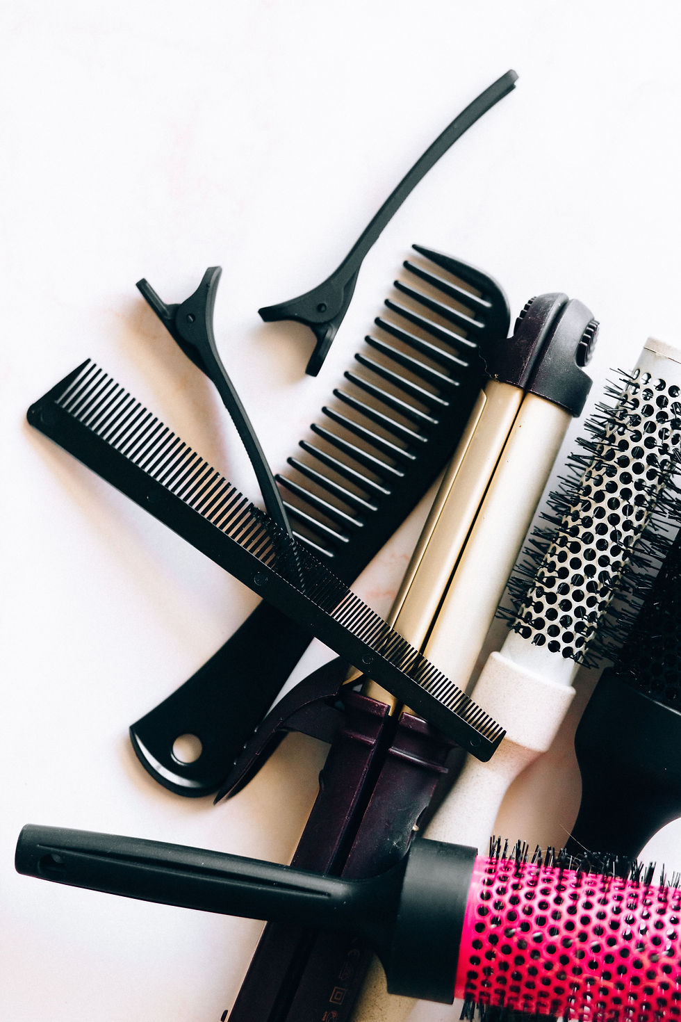 Selection of hair styling tools including combs, brushes and sectioning clips.