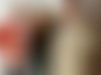 Three stylish people pose confidently in a studio. One wears an 80s red patterned jacket, another's outfit is green high waisted trousers and an 80s vintage roll neck top with yellow sunglasses, and the third an 80s vintage beige mac.