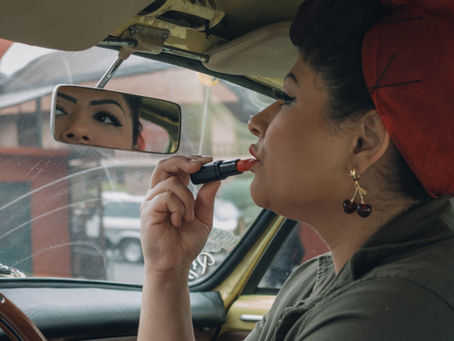Woman with vintage-inspired red lipstick and winged eyeliner