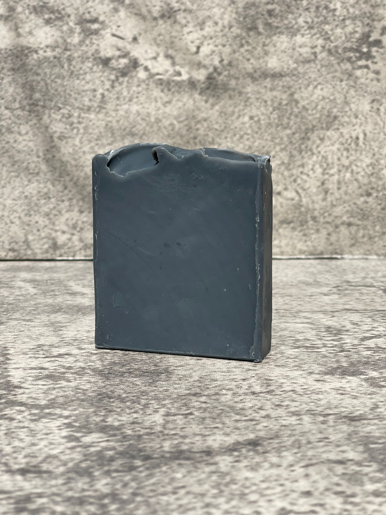 Grey soap bar on concrete