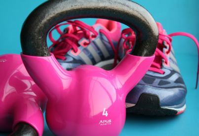 Running trainers and a kettlebell in our Llandysul studio, promoting strength and conditioning services specifically designed for runners.