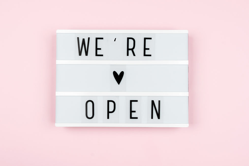 lightbox with the words WE are OPEN on a pink background. Starting a business after the pa