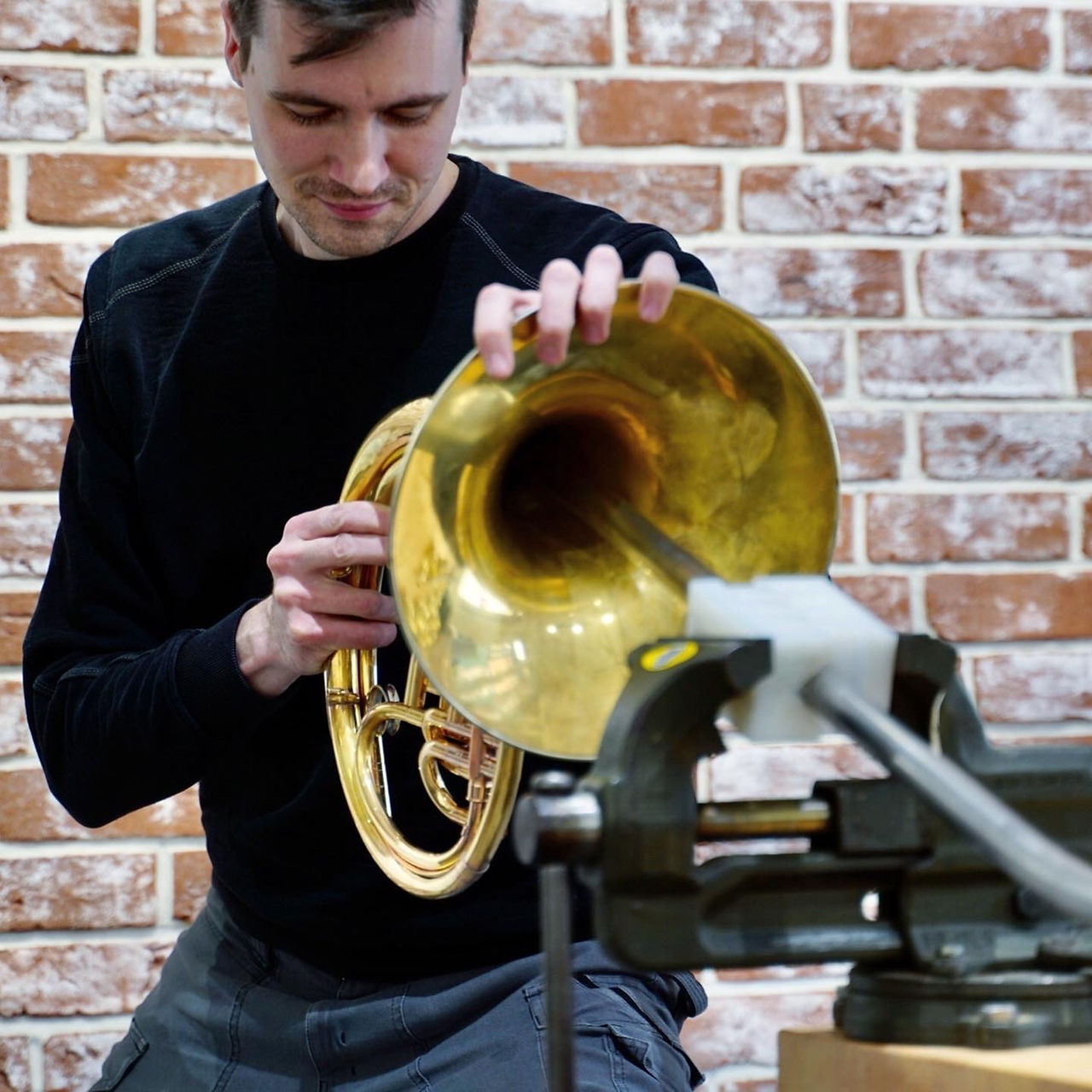 Felix Petersik denting a Yamaha Vienna horn in his brass instrument workshop on the outskirts of Berlin.