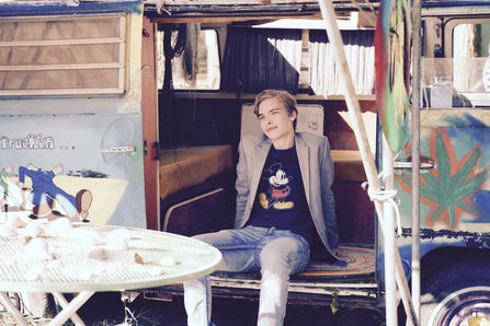 High school senior portrait of a young man sitting in an antique vehicle in the Twin Cities. Photographed by Bonni Allen.