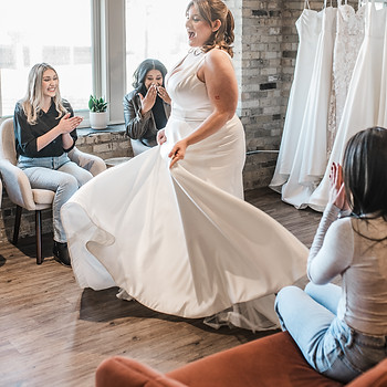 Bride and group members reacting to seeing bride in a dress for the first time