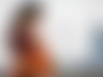 A pregnant woman (diverse ethnicity) holding her belly gently, with a subtle, blurred background showing a UK skyline or a UK flag.