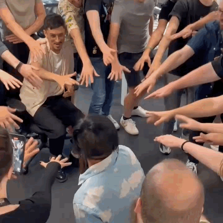 An animated gif of Ho-Yee leading a team of game devs in a "Go team!" gesture