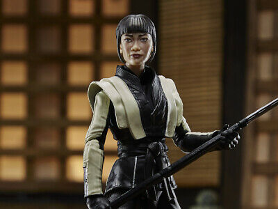 Action figure of a female character in black and white outfit, holding a sword