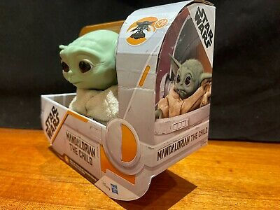 The Child (Grogu) plush toy in Mandalorian packaging