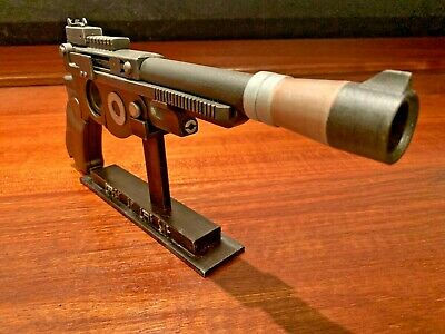 Detailed view of a futuristic pistol displayed on a stand