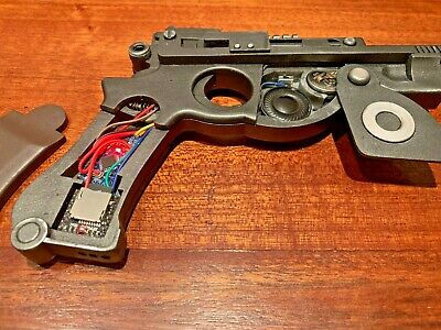 Disassembled model pistol revealing internal electronics