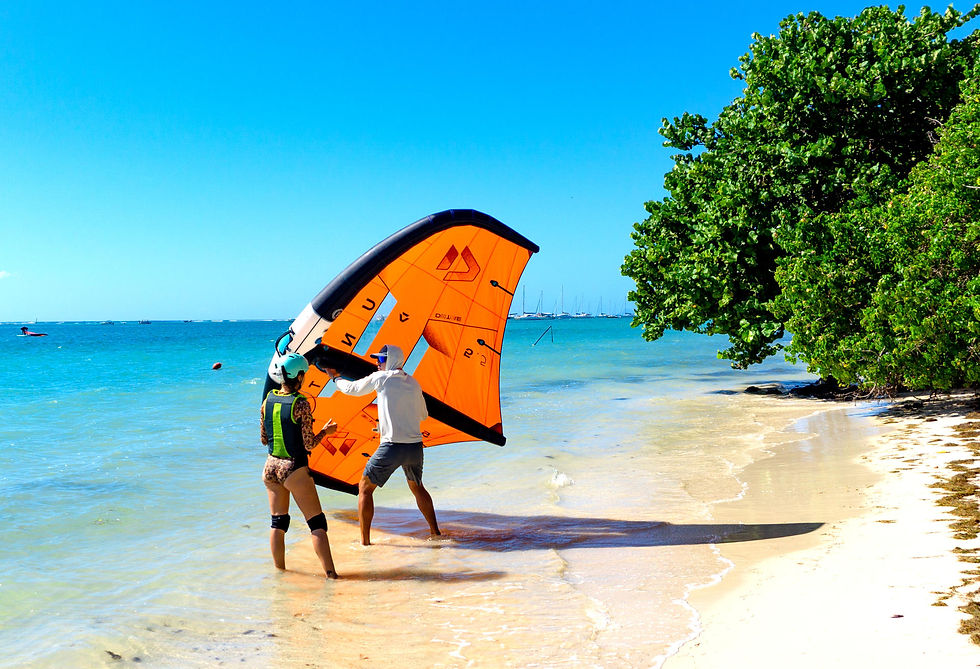 Moniteur Kawana qui guide un élève débutant en cours de wingfoil