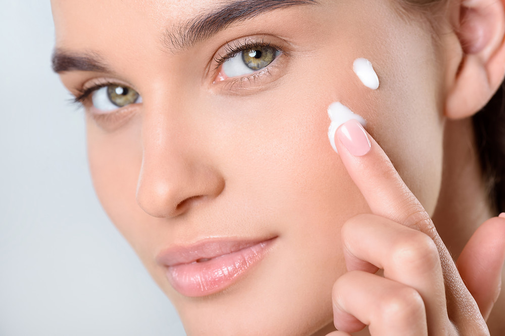 Beautiful-model-applying-skin-care-creams-best-beauty-products-to-buy for 2019.: ultimate-makeup-and-skin-care-must-haves