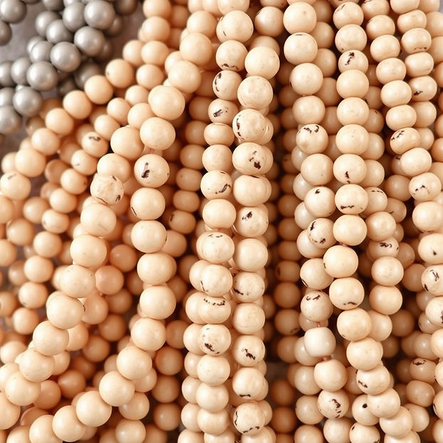 multiple hanks of neutral colored seed beads.jpg