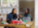 a woman sitting at a table in front of a window_edited.png