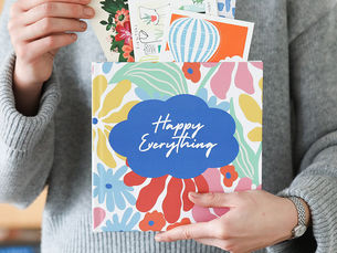 A finished Cardkive hardcover memory book with the photographed greeting cards tucked inside that will now get a beautiful home display as a coffee table book that can be enjoyed.