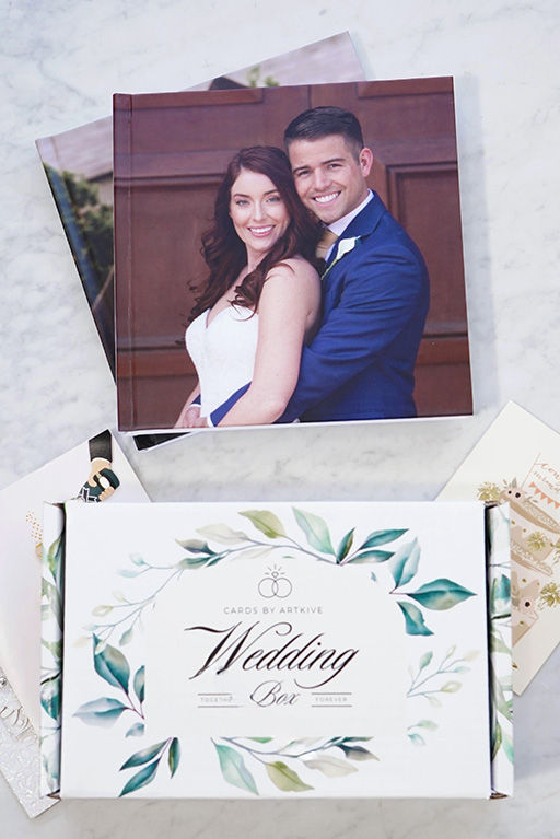 Cardkive Wedding Box packaging next to a finished wedding card keepsake book with a bride and groom photo on the cover