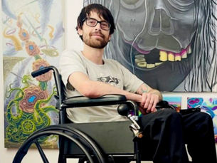 Profile photo of featured artist Adam St. George with his colorful canvas art