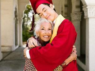 Blog icon image of grandson in cap and gown, hugging his grandmother at graduation, a milestone memory worth turning into a keepsake
