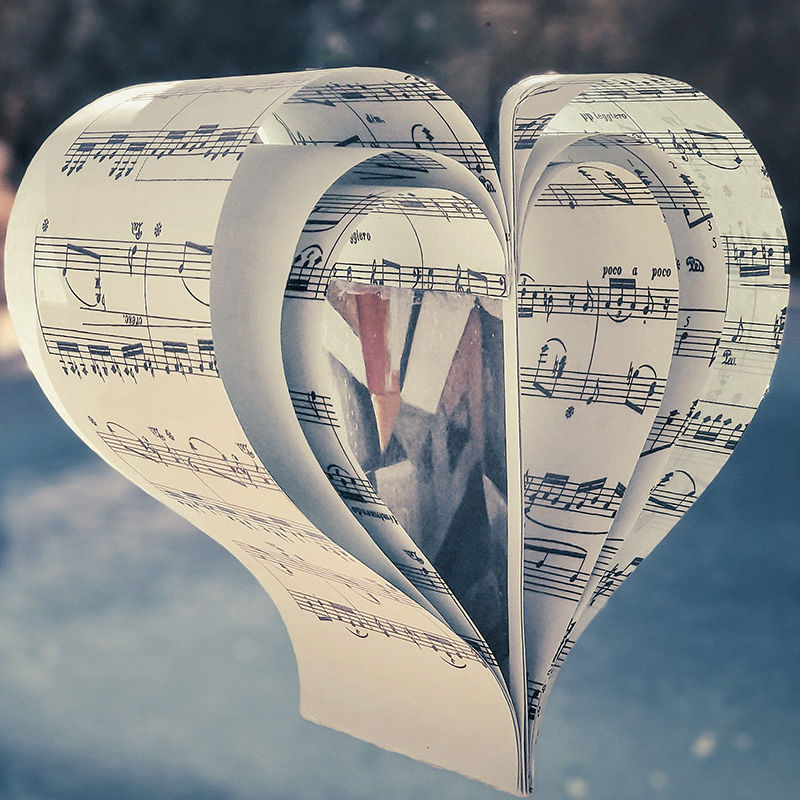 Heart-shaped keepsake folded from sheet music pages with a small photo tucked inside