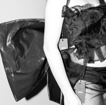 Detailed shot of MONA custom fashion designs featuring tailored textures and accessories.