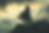 Silhouette of the horned figure of Loki with a spear stands on a rocky peak, cloak billowing. Dramatic sky and snowy mountains fill the background.