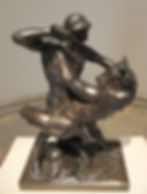Bronze sculpture of a man battling a rearing minotaur on a pedestal. The man wields a club; background is neutral and simple.